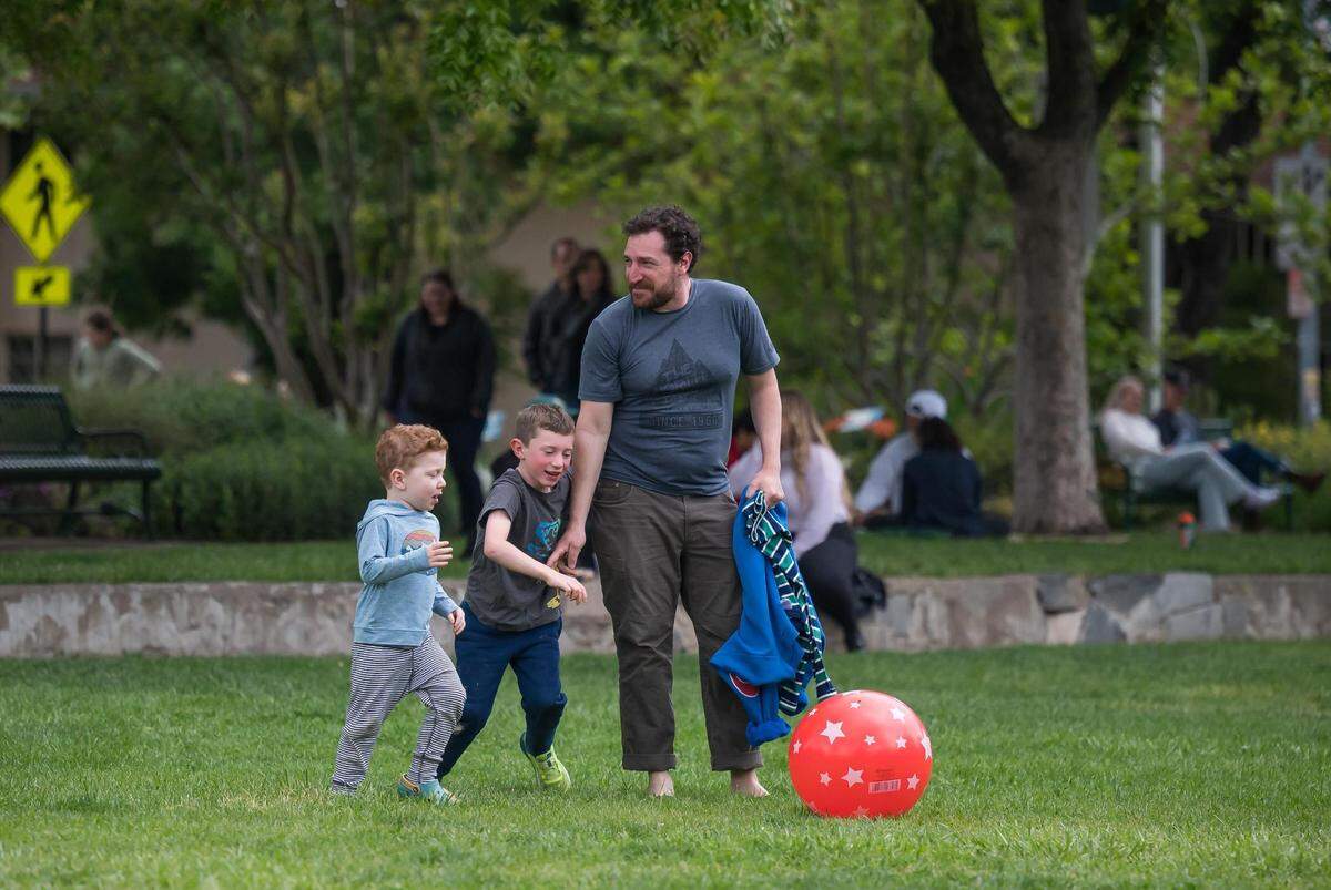 Jason Wiener, of Davis, plays with his sons, 4-year-old Edward Landman-Wiener, left, and 6-year-old Alfred Landman-Wiener, on Saturday, May 6, 2023, in Central Park. Wiener said he knows Majdi Abou Najm — father of Karim Abou Najm who was fatally stabbed April 29 — through his studies at UC Davis.