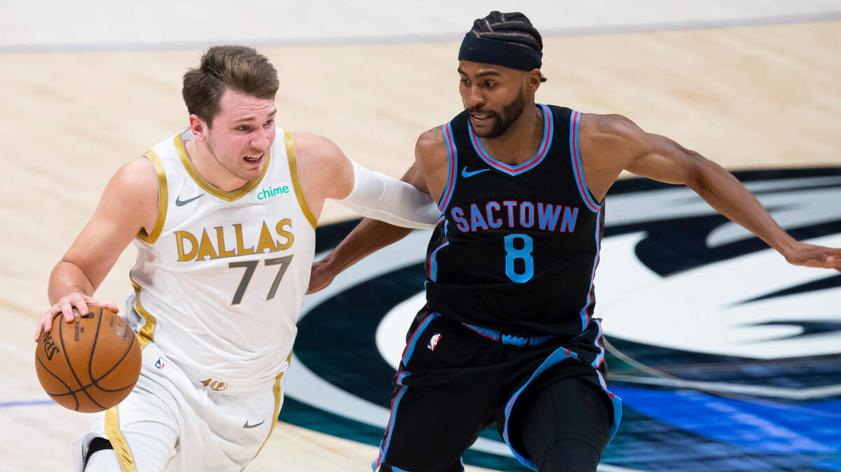 Dallas Mavericks guard Luka Doncic, left, battles Sacramento Kings forward Maurice Harkless, right, for space during the first half of a NBA basketball game, Sunday, April 18, 2021, in Dallas. (AP Photo/Brandon Wade)