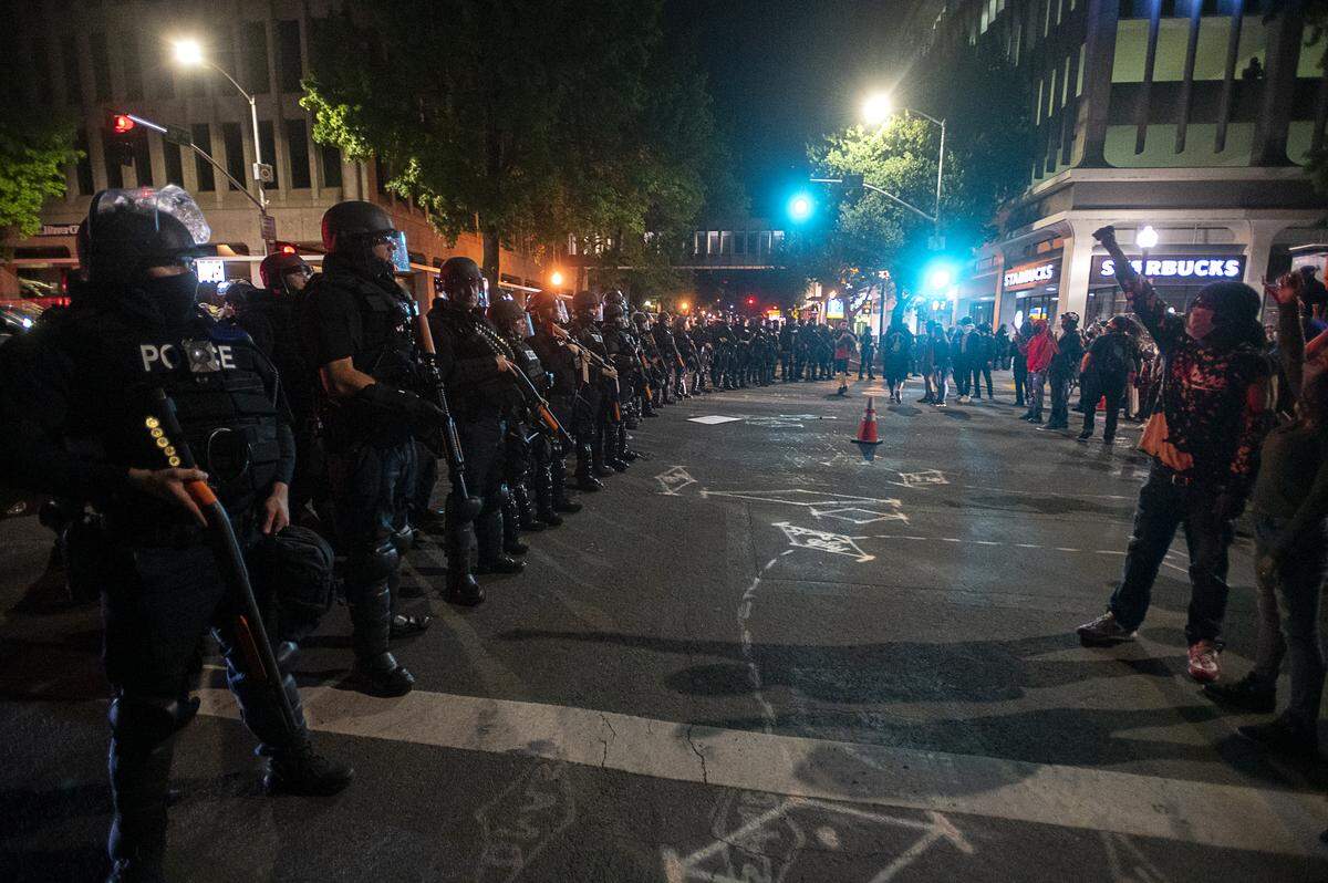 Demonstrators face off with Sacramento Police at L and 10th streets in Sacramento on Sunday during a protest over the death of George Floyd, who died in Minneapolis on May 25 after being detained by police.