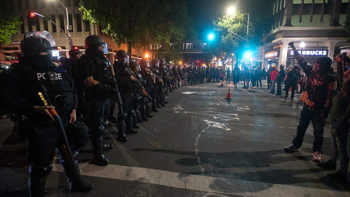 Demonstrators face off with Sacramento Police at L and 10th streets in Sacramento on Sunday, May 31, 2020, during a protest over the death of George Floyd, who died in Minneapolis on May 25 after being detained by police.
