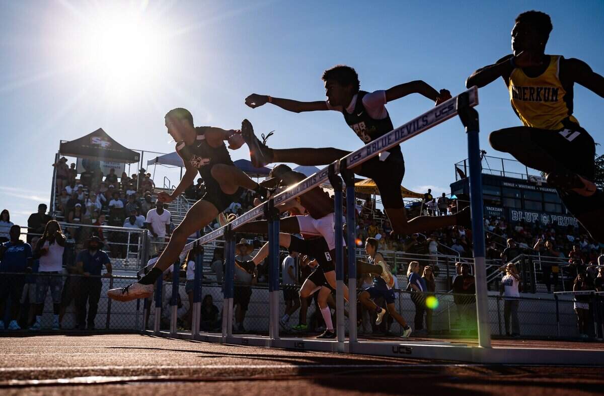 Woodcreek High School’s Isaiah Earls, left, leads a pack of hurdlers in the boys 110-meter race at the CIF Sac-Joaquin Section Masters track and field finals at Davis High School on Saturday.