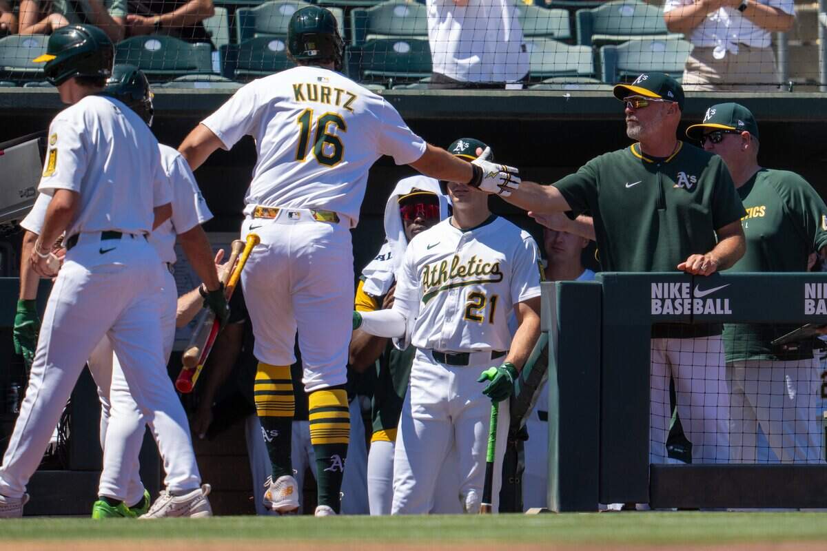 Aug 17, 2025; West Sacramento, California, USA; Athletics first baseman Nick Kurtz (16) celebrates with Athletics manager Mark Kotsay (7) after hitting a solo home run against the Los Angeles Angels during the third inning at Sutter Health Park. Mandatory Credit: Neville E. Guard-Imagn Images
