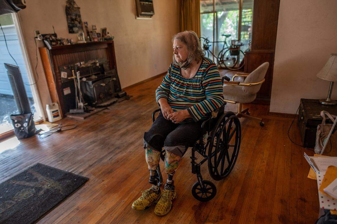 Linda Siegrist, 67, a double amputee since 2016 due to diabetes, surveys her home in November and says she’s worried about losing it in the receivership process. She says crews disposed of her grandmother’s antique furniture and the legs of her wheelchair when the receiver took possession of the house, parts of which the receiver said were inaccessible due to hoarding. “I don’t need a whole lot but just don’t take what I have,” Siegrist said.