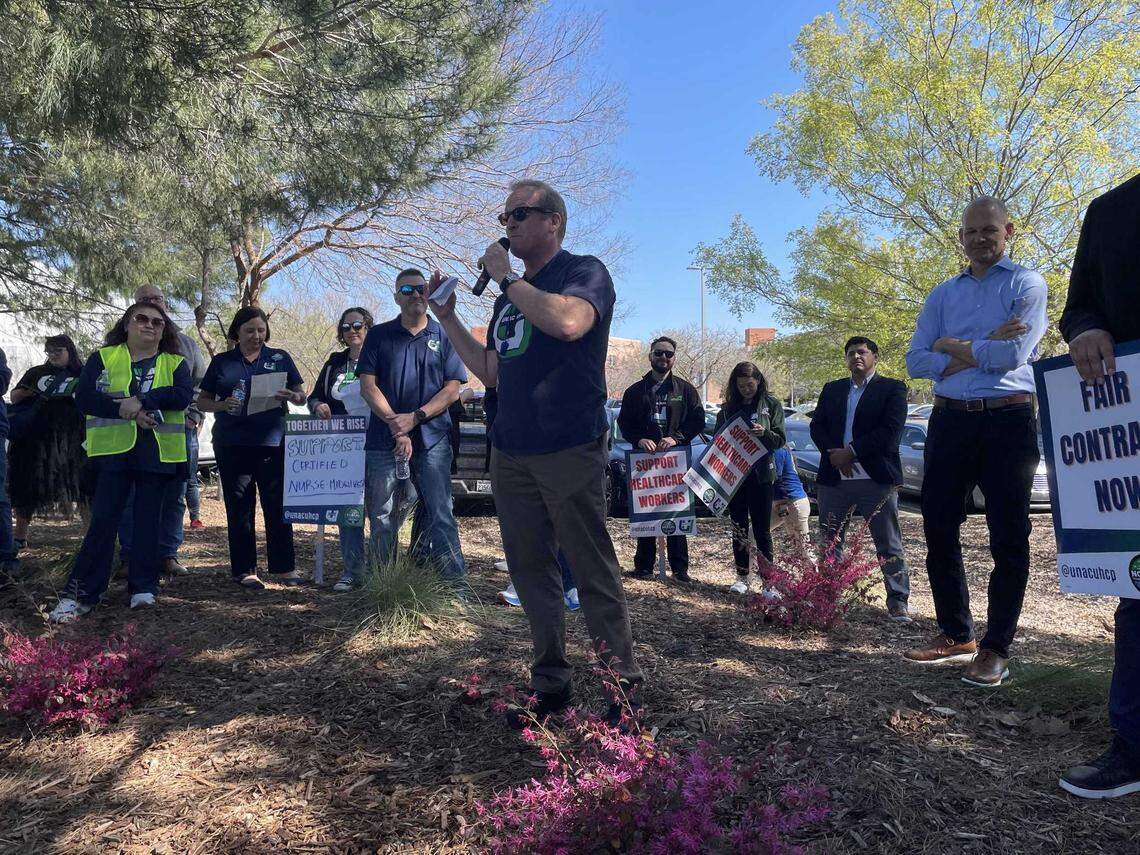 Union workers and supporters look on as Ross Madden, a physician’s associate and member of United Nurses Associations of California/Union of Health Care Professionals, speaks at a rally at Kaiser Permanente Roseville Medical Center on March 11, 2025.