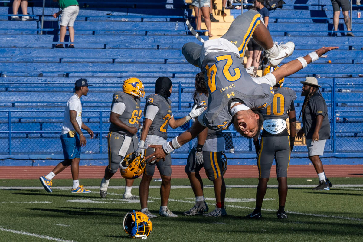The Grant Pacers’ Tyson Grifffin Jr. (24) celebrates with a back flip after the team’s victory over the Inderkum Tigers on Saturday at Grant High School.