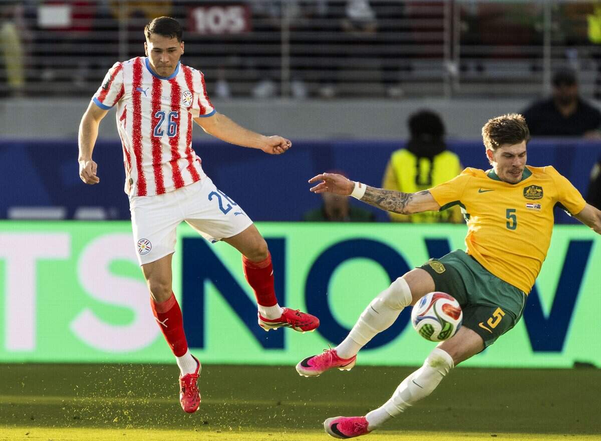 Paraguay defender Alexandro Maidana (26) fights for the ball against Australia defender Jordan Bos (5) during their match in the group stage of the 2026 World Cup at Levi’s Stadium on Thursday in Santa Clara.