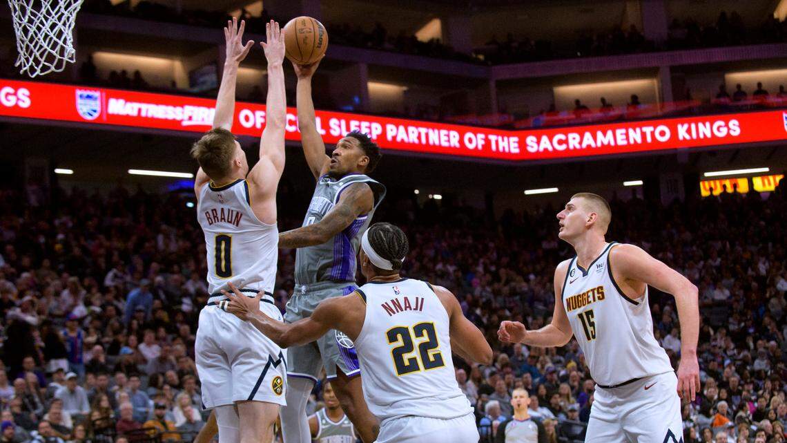 Sacramento Kings guard Malik Monk shoots over Denver Nuggets guard Christian Braun (0) during the second half of an NBA basketball game in Sacramento, Calif., Wednesday, Dec. 28, 2022. The Kings won 127-126. (AP Photo/Randall Benton)