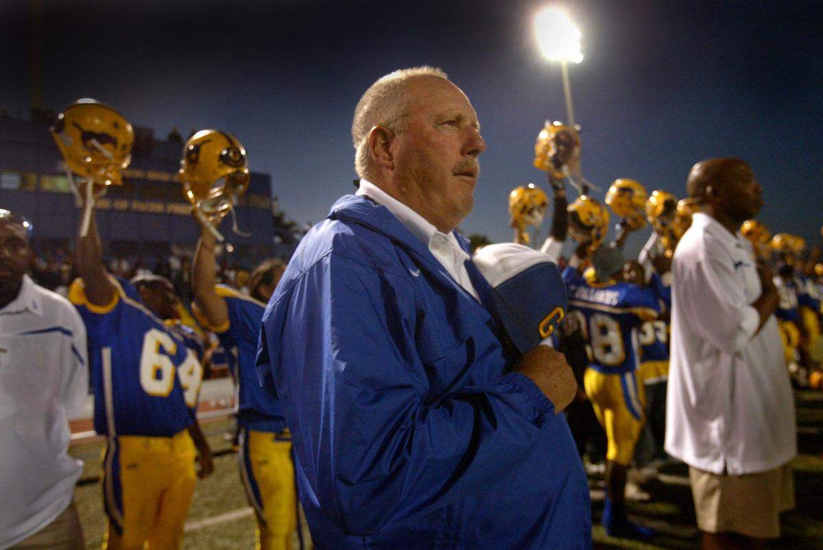 Grant head coach Mike Alberghini takes one of the only quiet moments he has before the start of a game – during the national anthem – against Oak Ridge at home on Sept. 22, 2006.