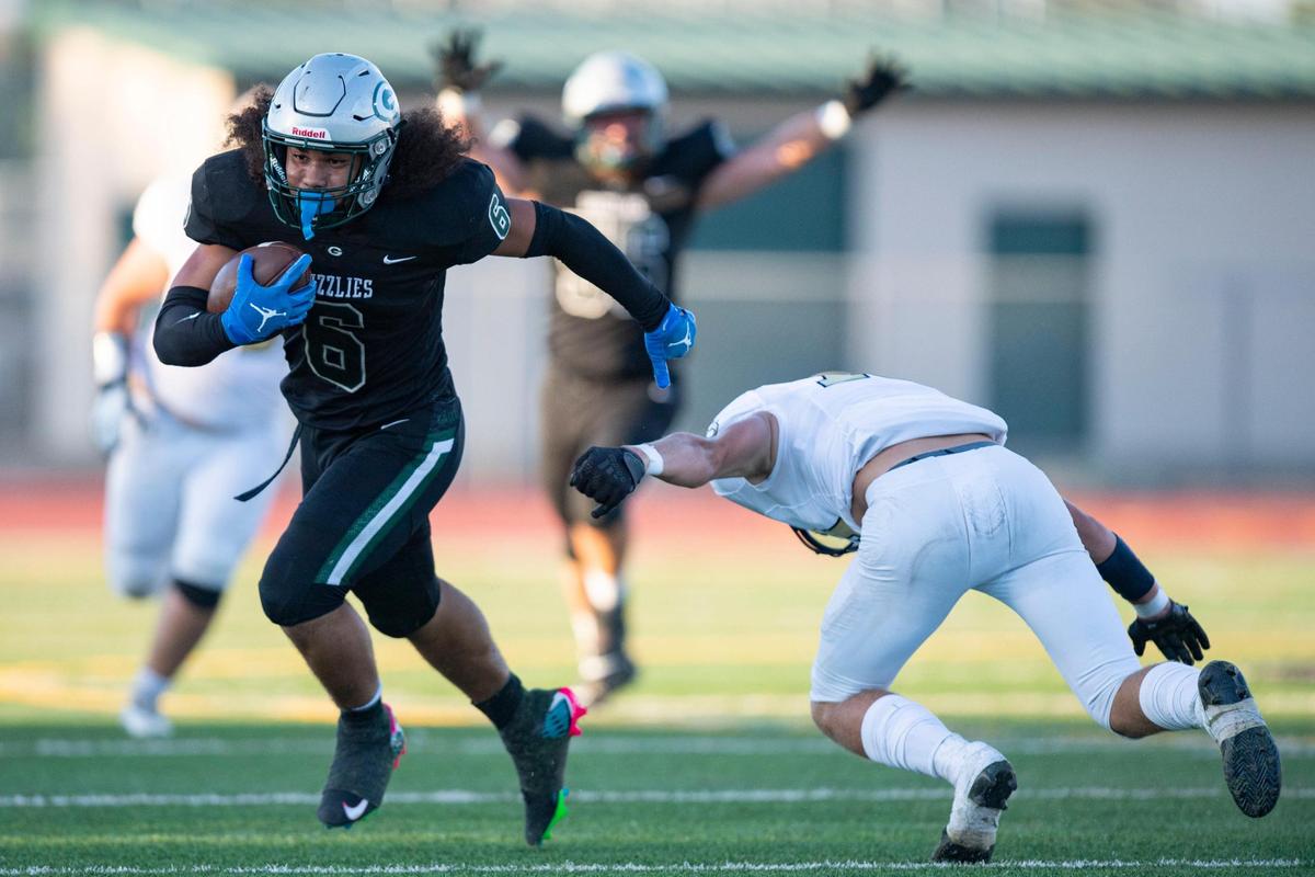 Granite Bay Grizzlies running back Isaiah Ene (6) jukes Elk Grove Thundering Herd safety Adam Beam (19) during the first half at Granite Bay High School on Friday, Aug. 18, 2023, in Granite Bay.