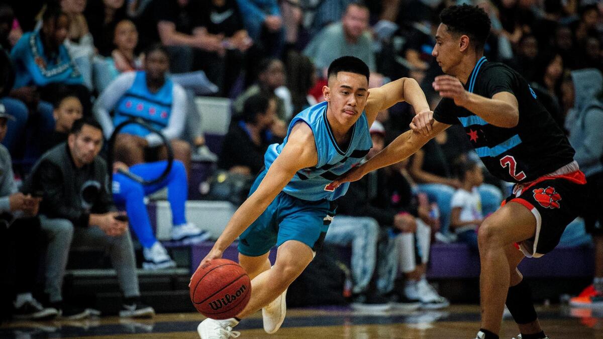 Justin Nguyen (11), a member of the Boys’ Large Schools South Team, drives the ball down the court during the Optimist All-Star boys basketball game at Sacramento High School on Saturday, April 6, 2019.