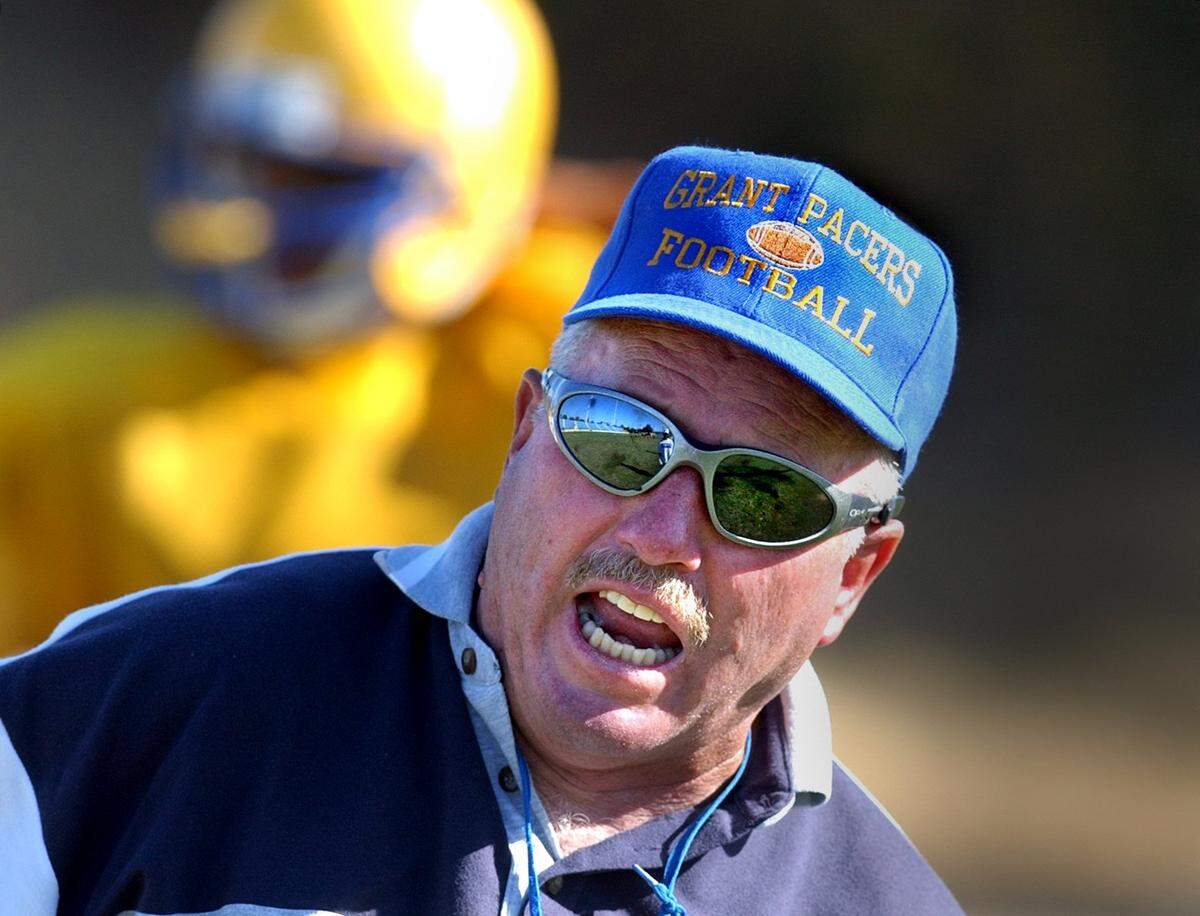 Mike Alberghini, head coach of top-ranked Grant High School, yells at some of his players for taking an extra long water break during a practice on Monday, Aug. 27, 2001.