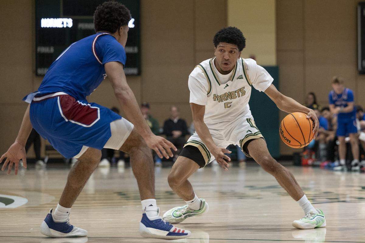 Sacramento State guard Jayden Teat (5) keeps the ball away from the defense during a game between Sac State and Presbyterian at Hornet Pavilion in Sacramento on Sunday, Nov. 16, 2025.