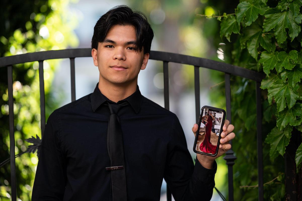 Bradshaw Christian High School student Tomas Roberts, 18, voted Sacramento Porch Prom King, holds a photo of his girlfriend in her prom dress while he is photographed in front of his home Tuesday, April 28, 2020, in Sacramento County.