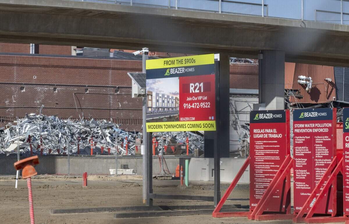 A sign on 21st Street behind the Sacramento Bee earlier this month advertises future town homes starting at $900,000. 