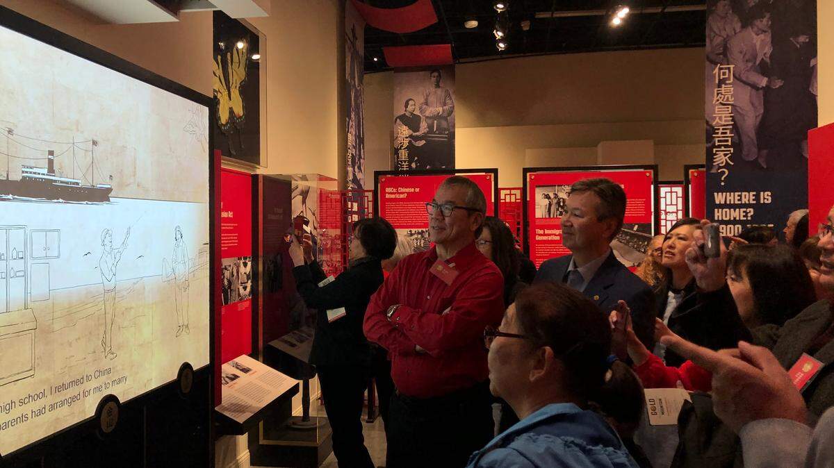 Visitors watch an animated video about the story of Dr. Henry Yee, Chinese American who came to the U.S. in 1908, at the California Museum in Sacramento on Jan. 26, 2020. 