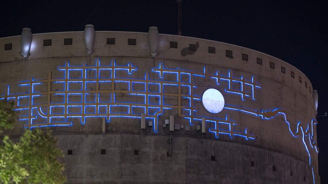 What does it mean? Bright blue art engulfs concrete tower behind a Sacramento Safeway