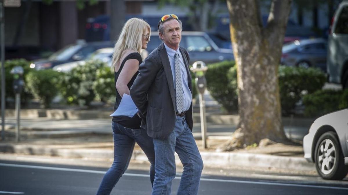 Michael Lyon crosses G Street with his girlfriend Shannon Campbell after he was found guilty on eight counts including eavesdropping on April 24, 2018 by a Sacramento jury. He is to be sentenced May 25.