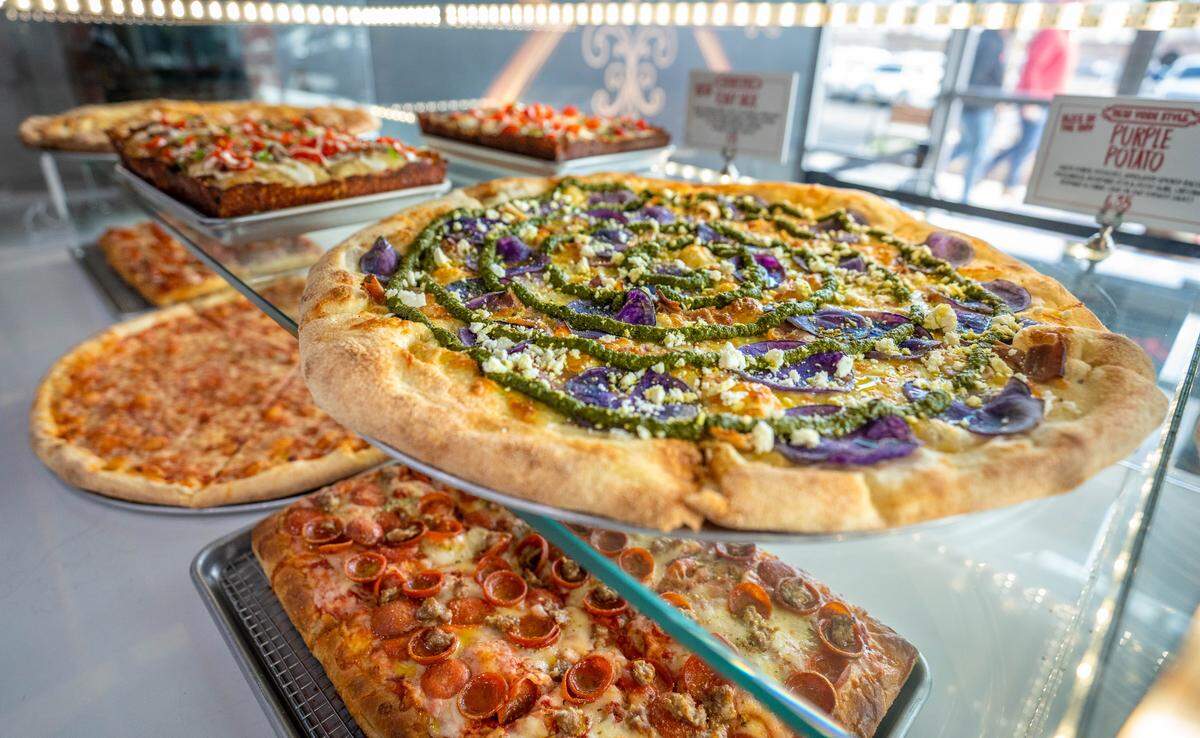 The Purple Potato pizza and many others sit in the viewing window ready for customers at Slice House by Tony Gemignani on Thursday, Feb. 1, 2024.
