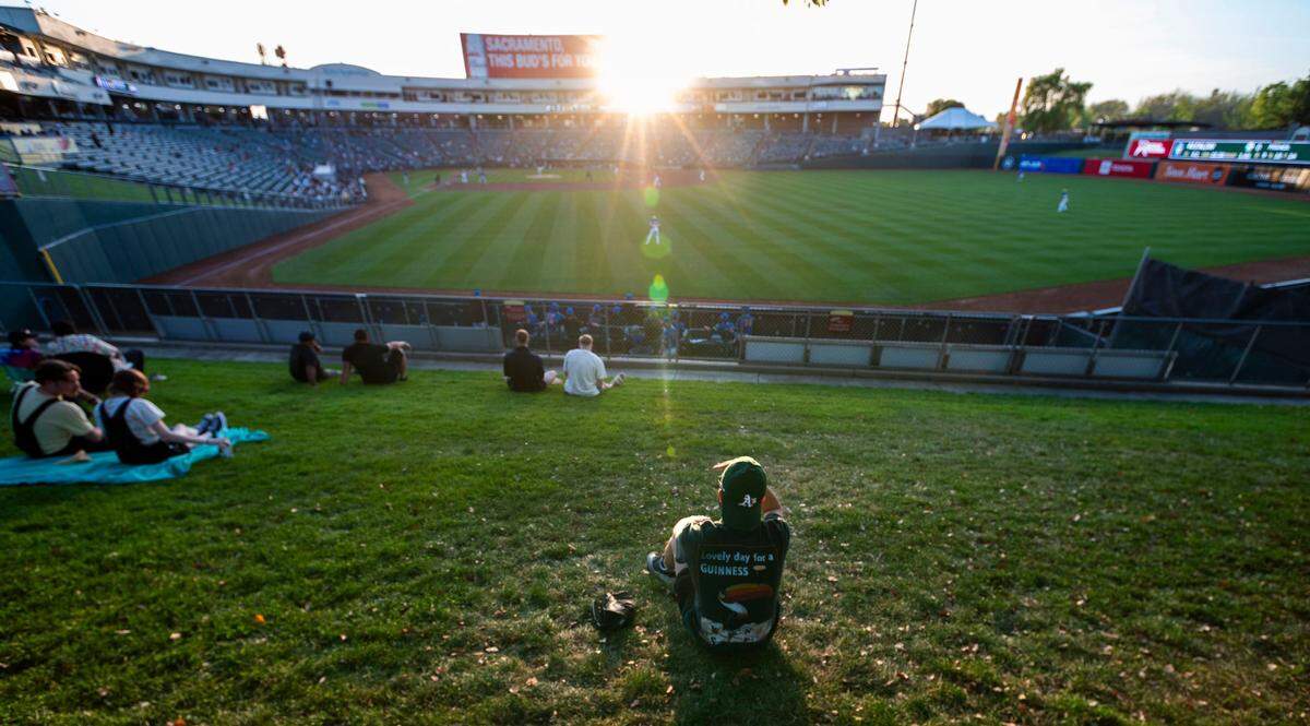 An Oakland A’s fan watches a Sacramento River Cats game Tuesday, April 9, 2024, at Sutter Health Park.