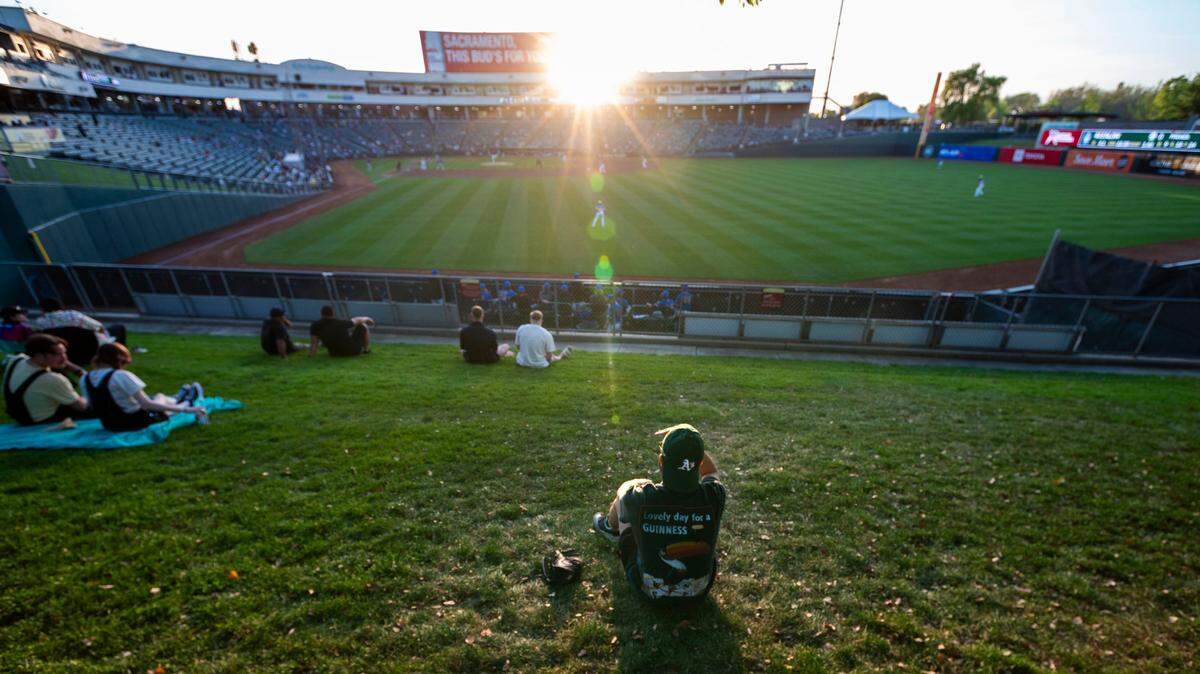 An Oakland A’s fan watches a Sacramento River Cats game Tuesday, April 9, 2024, at Sutter Health Park.