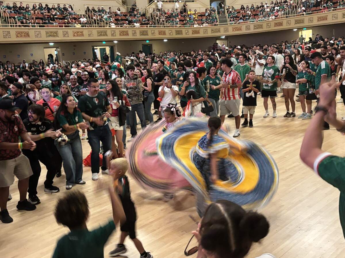 Two young fans dance in folklorico dresses ahead of the Mexico-Ecuador World Cup match at the Sacramento Republic FC’s watch party at Sacramento Memorial Auditorium on Tuesday.