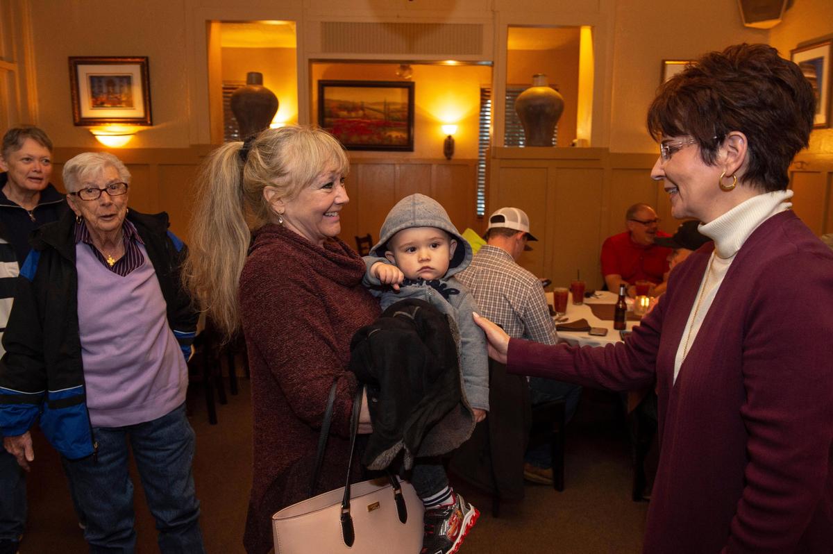 Co-owner Patti Palamidessi, right, greets incoming customers Dianna Nugent, who holds her grand nephew, Ben Jeffery, at Club Pheasant on Feb. 26, 2019. Palamidessi said one of the secrets to the restuarant’s 83-year run is to make everyone feel like family.