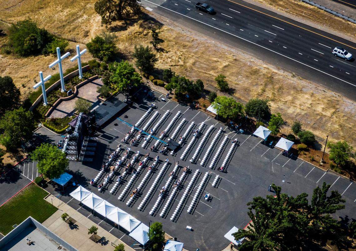 Members of Destiny Christian Church in Rocklin sit with social distance as they worship at an outdoor seating area for an indoor service held in July 2020.