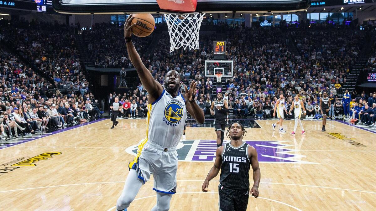 Golden State Warriors forward Draymond Green (23) drives to the basket after a steal as Sacramento Kings guard Davion Mitchell (15) watches during an NBA game between the Sacramento Kings and the Golden State Warriors on Friday, April, 7, 2023 at Golden 1 Center.