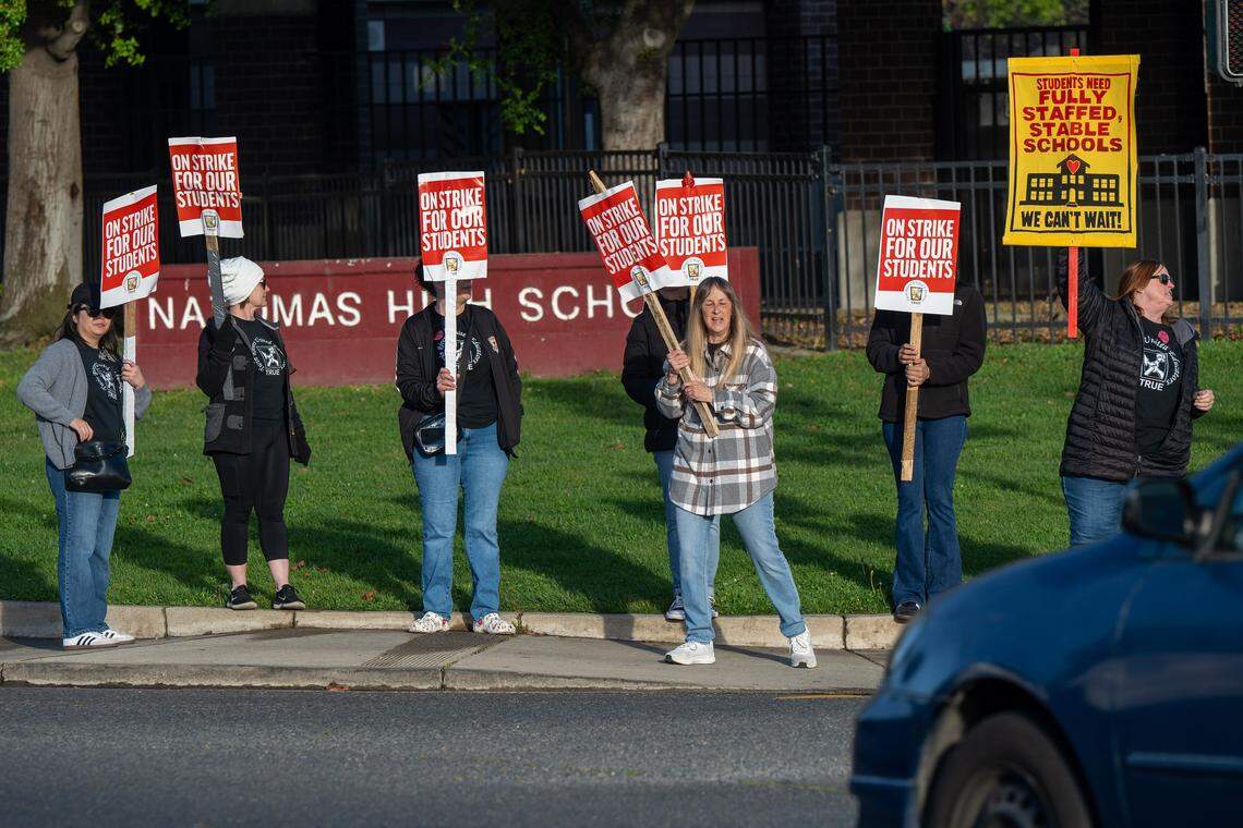 Supporters hold signs in front of Natomas High School in Sacramento during the first teacher strike in the Natomas Unified School District on Tuesday, March 10, 2026.