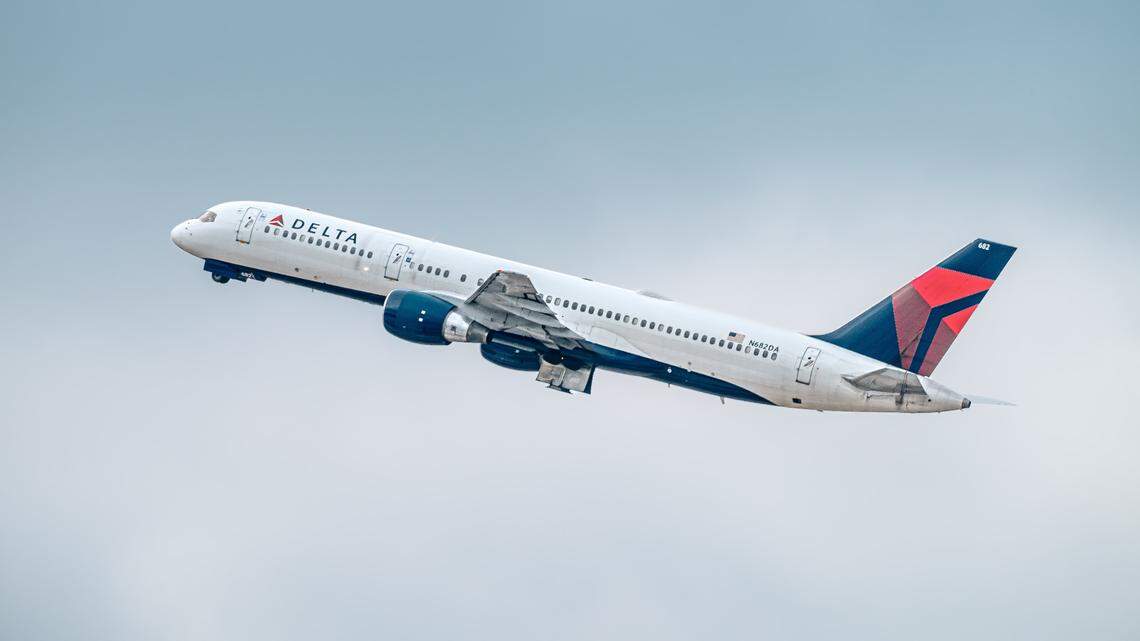 A Delta airliner returned to the Los Angeles International Airport gate after a passenger deployed an emergency slide, California police say.