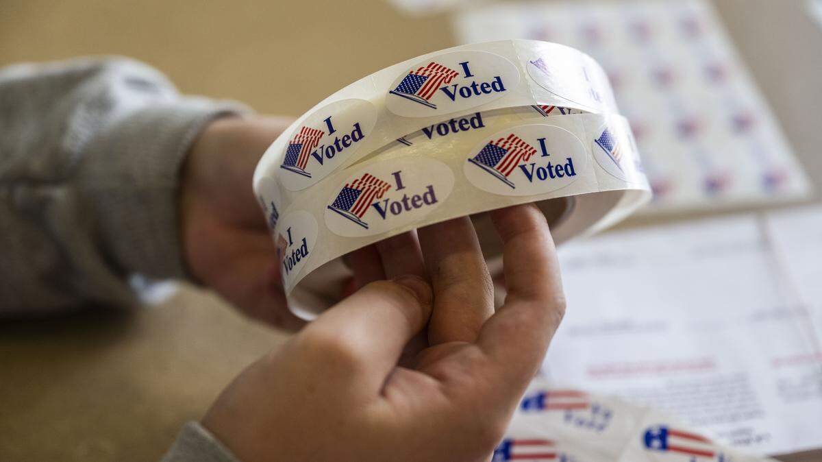 A student election clerk holds "I voted" stickers for Folsom residents at Folsom Lake College on Tuesday, Nov. 4, 2025. The California secretary of state’s office is responsible for overseeing elections. 