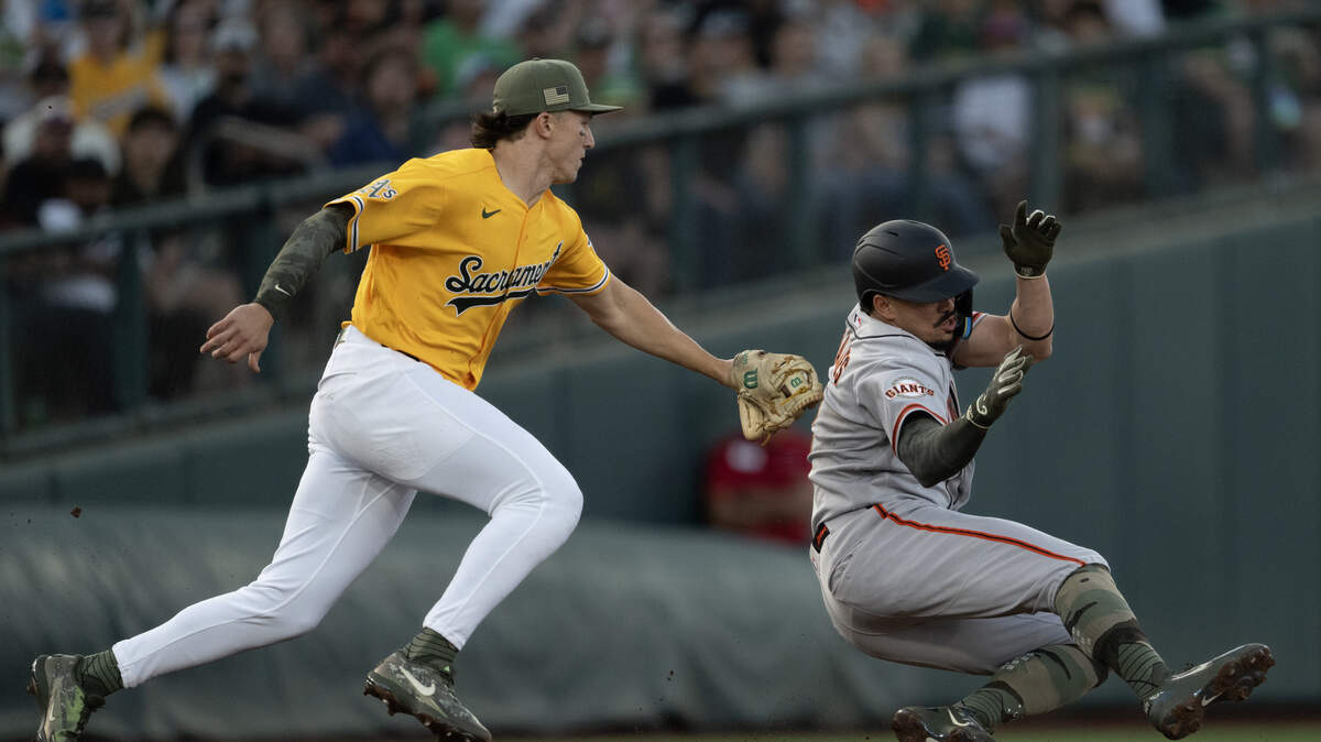 Athletics Zack Gelof (20) tags out San Francisco Giants shortstop Willy Adames (2) as he tried to advance to third on an infield ground ball in the fourth inning at Sutter Health Park on May 16. The Giants and A’s will face off for the second and final time this season from Tuesday to Thursday.