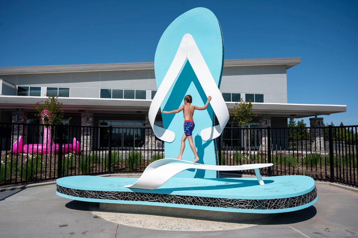 Graham Johnson, 9, climbs on a play structure of giant flip flops at the official grand opening of the North Natomas Community Center and Aquatics Complex on Saturday, April 23, 2022.