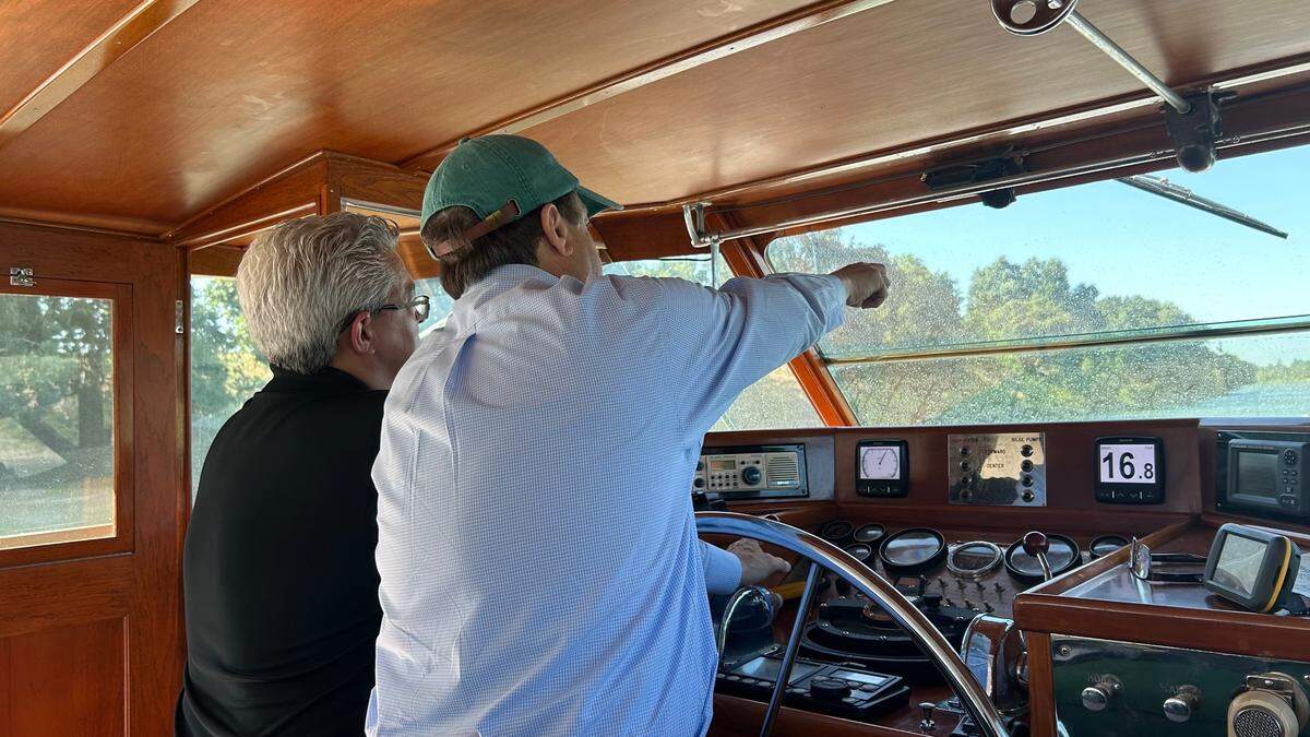 Gerry Kamilos points out a buoy to Deacon Kevin Staszkow on Friday. Kamilos steered the Aurora V down the Sacramento River for the entirety of a procession planned to travel from Vallejo to Sacramento.