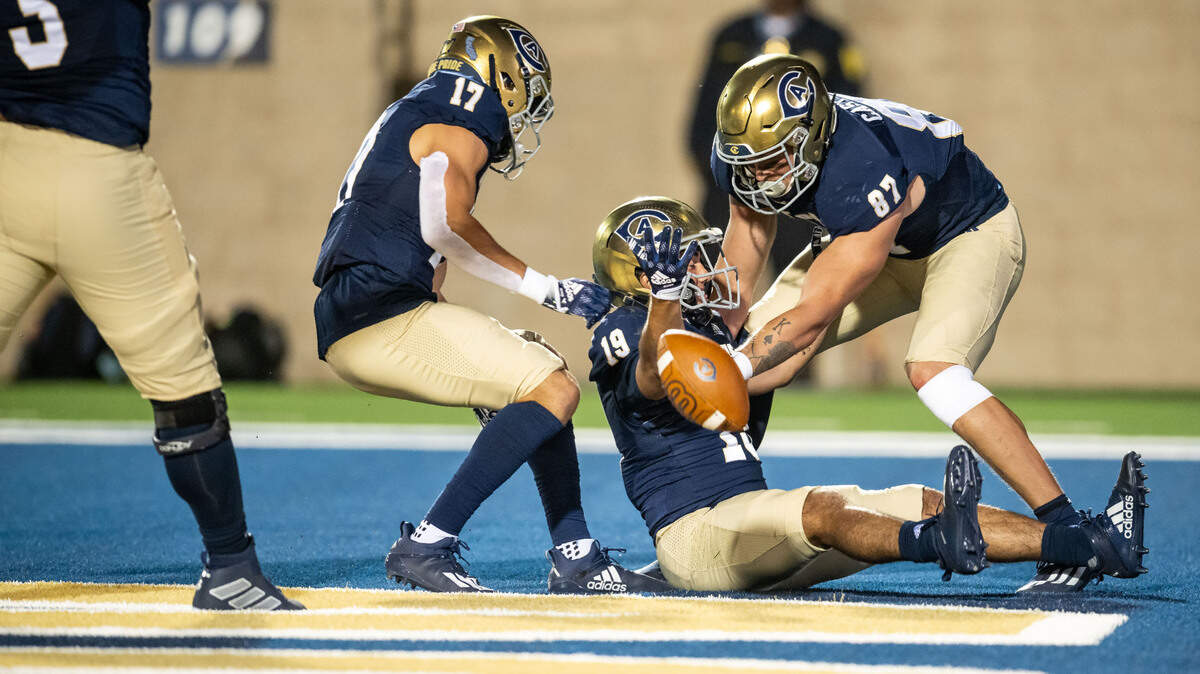 UC Davis Aggies running back Matteo Perez (19) tosses the ball in celebration while in a seated position after running in to score during the second quarter against the University of San Diego at the NCAA college football game Saturday, Sept. 17, 2022, at UC Davis Health Stadium.