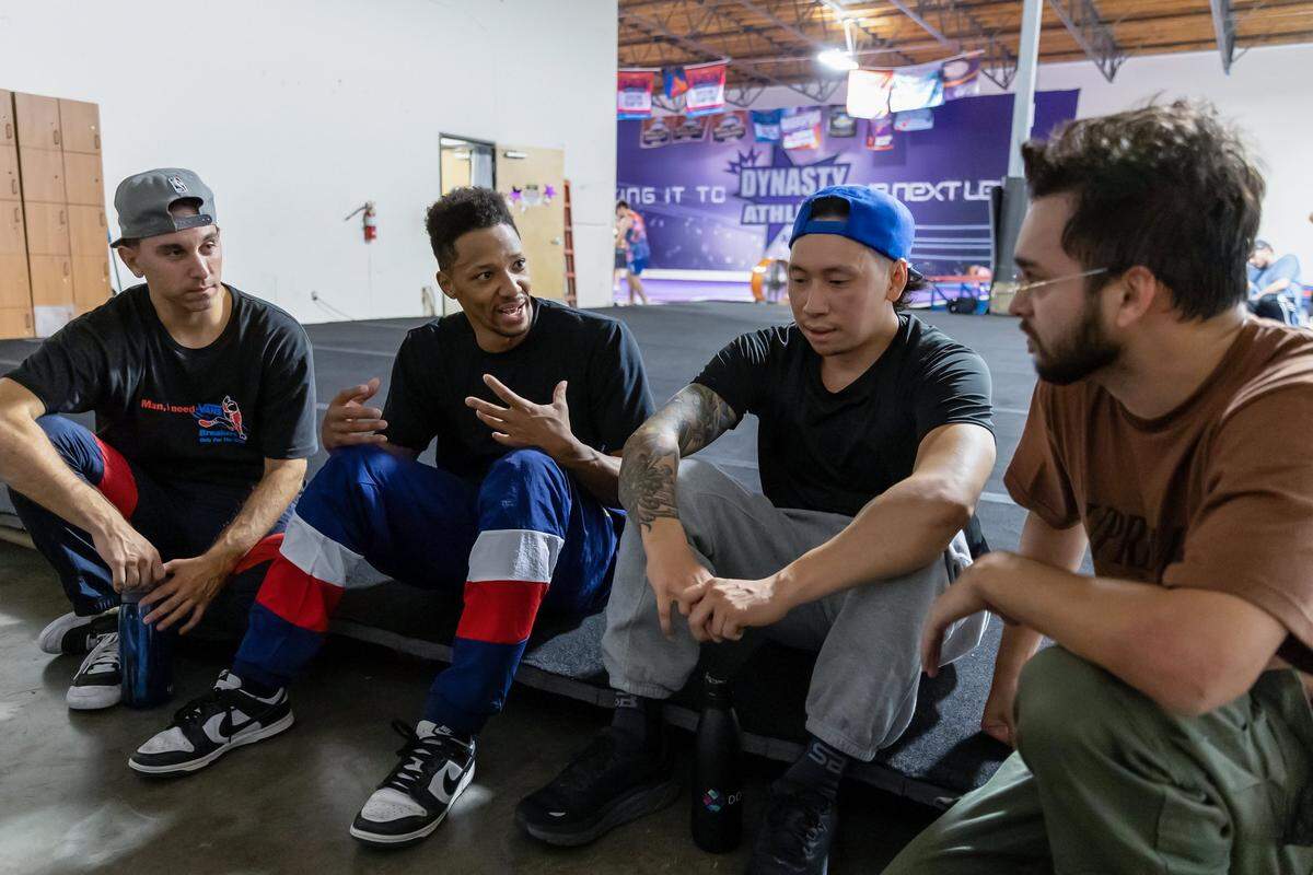 Morris Isby, second from left, talks to other dancers about branding during practice in September at Dynasty Athletic gym in Sacramento. Isby hopes to earn a spot on the 2024 U.S. Olympic team in breakdancing.