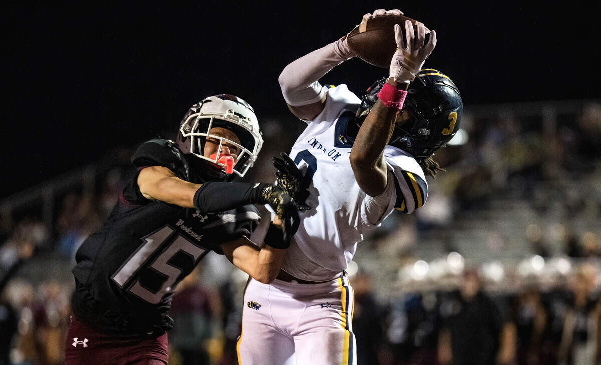 The Inderkum Tigers’ LeAndrew Jenkins (3) makes a touchdown reception as the Woodcreek Timberwolves' Dwayne Mosley (15) defends in the second half on Friday, Oct. 17, 2025, in Roseville.