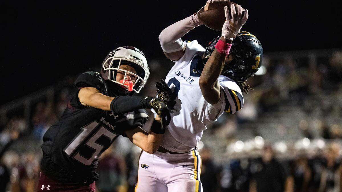 The Inderkum Tigers’ LeAndrew Jenkins (3) makes a touchdown reception as the Woodcreek Timberwolves’ Dwayne Mosley (15) defends in the second half on Friday in Roseville.