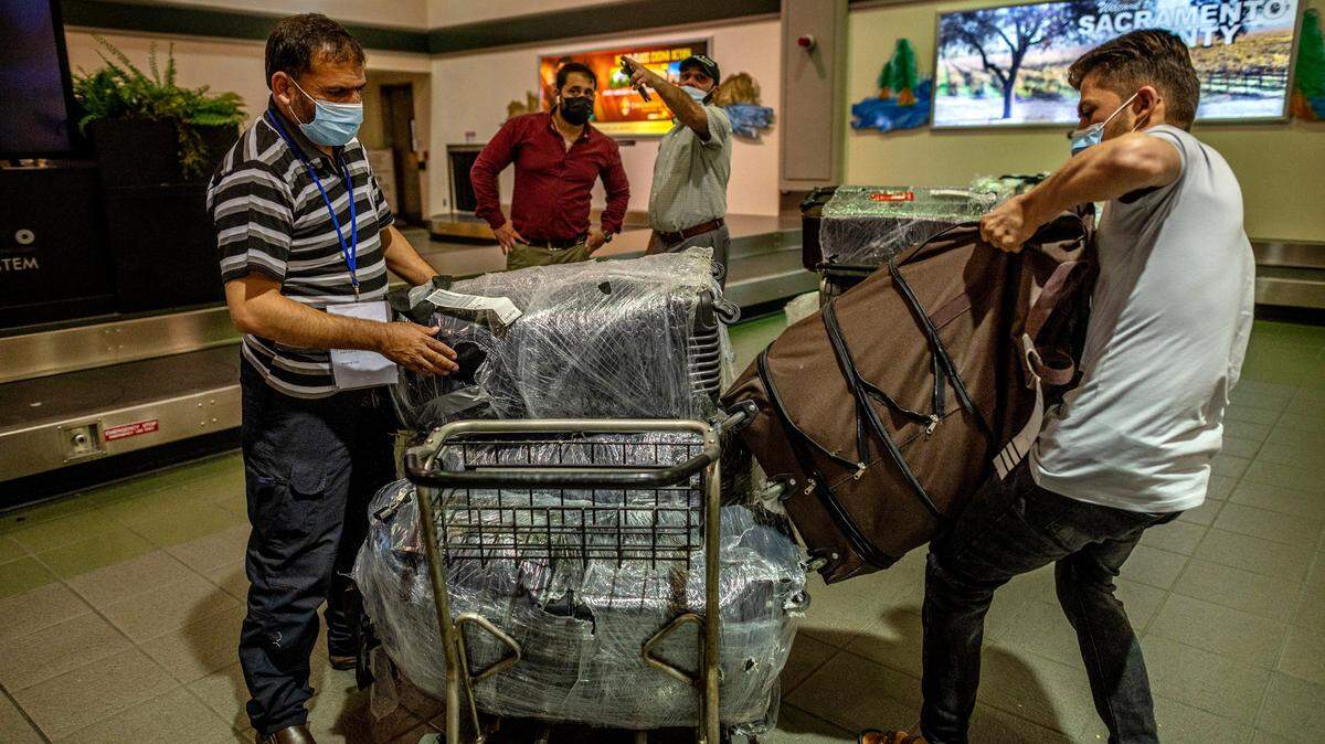 An Afghan refugee family arrives at Sacramento airport. Other families are expected to settle in San Luis Obispo County.