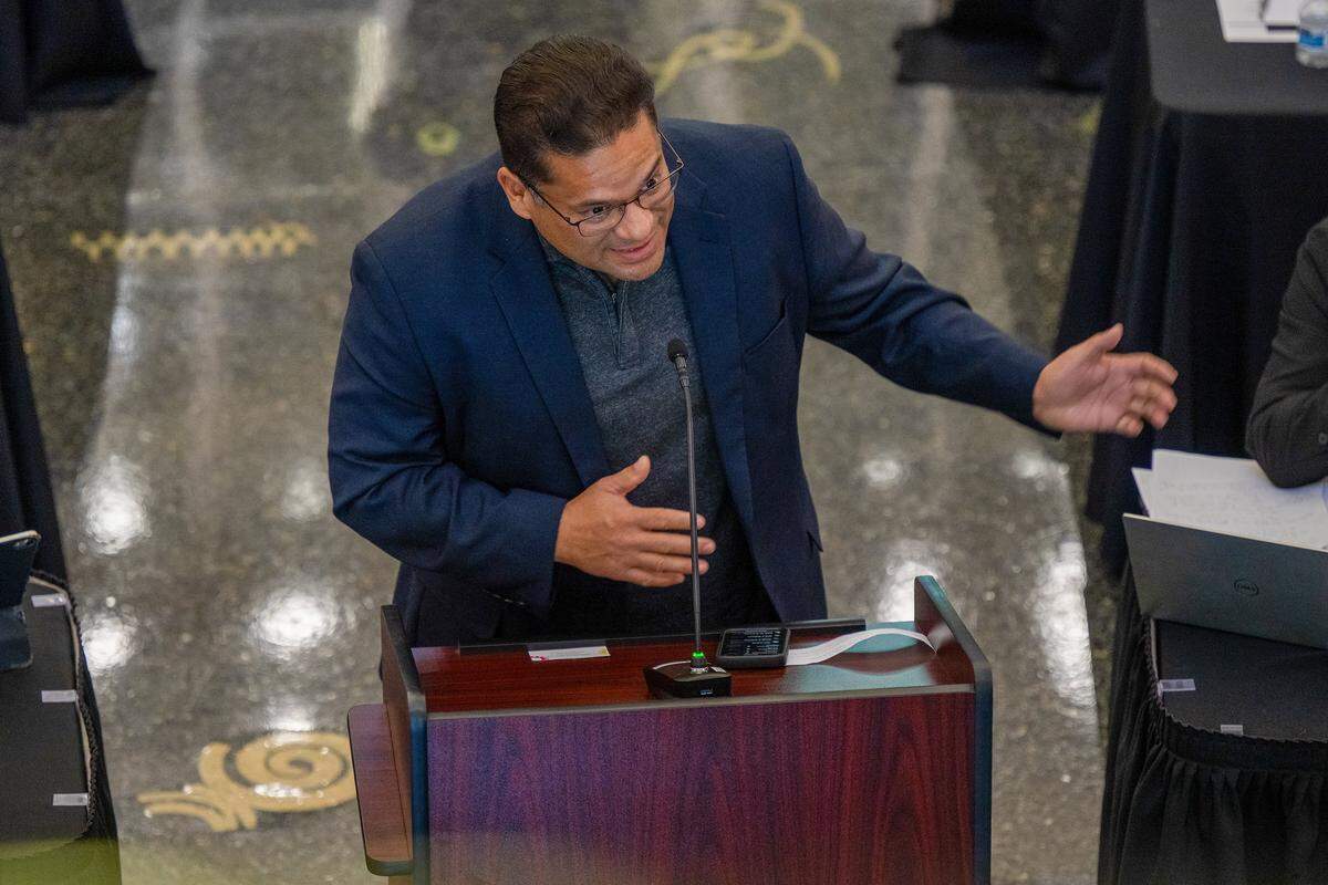 Herman Barahona, founder of the Sacramento Environmental Justice Coalition, gestures during public comment during a county-city meeting on homelessness at the Tsakopoulos Library Galleria in Sacramento on Tuesday as he spoke on behalf of the “six people who died” from Camp Resolution.