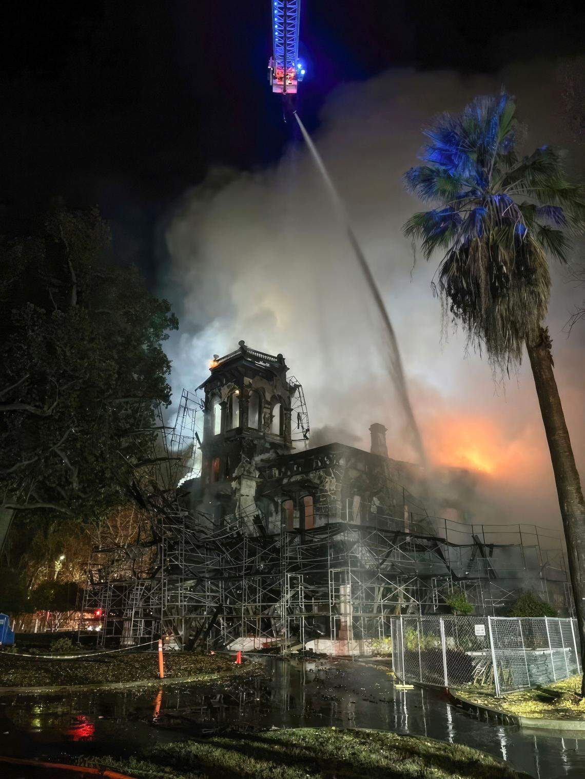 Firefighters attempt to extinguish a blaze at the Bidwell Mansion, a California State Historic Park building in Chico, before dawn on Wednesday, Dec. 11, 2024.