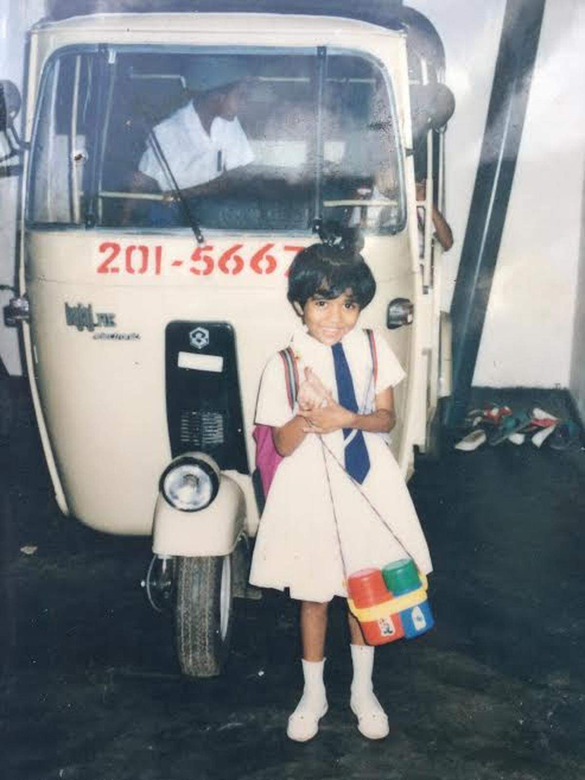 Manushi Weerasinghe stands next to her family’s tuk tuk at their house in Colombo, Sri Lanka in 1997. 