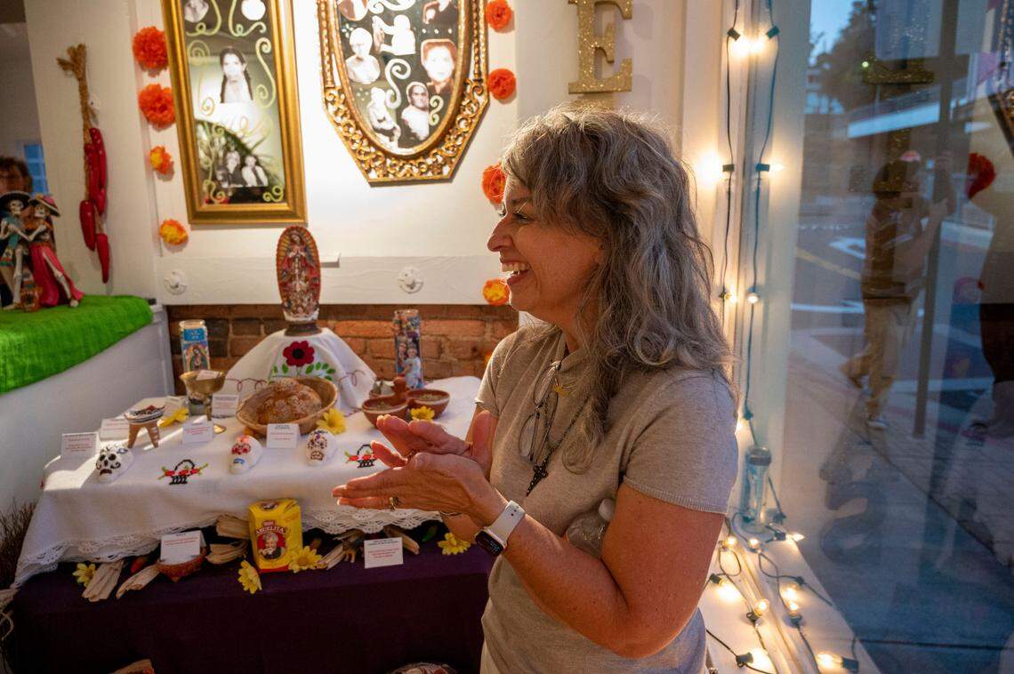 Penny Smart talks about her abuela making tortillas by hand, at an ofrena she decorated in her honor, at Center Street Gallery on Thursday, Oct. 19, 2023, for Placerville’s Dia de los Muertos.