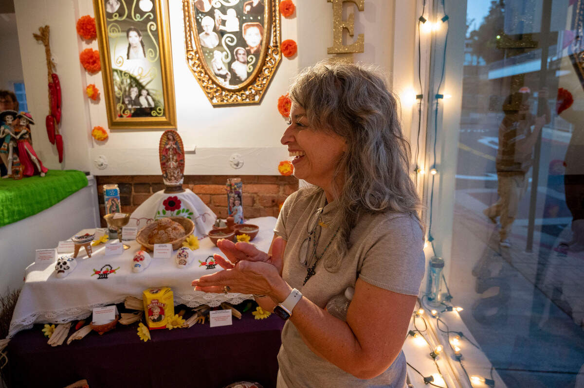 Penny Smart talks about her abuela making tortillas by hand, at an ofrena she decorated in her honor, at Center Street Gallery on Thursday, Oct. 19, 2023, for Placerville’s Dia de los Muertos.