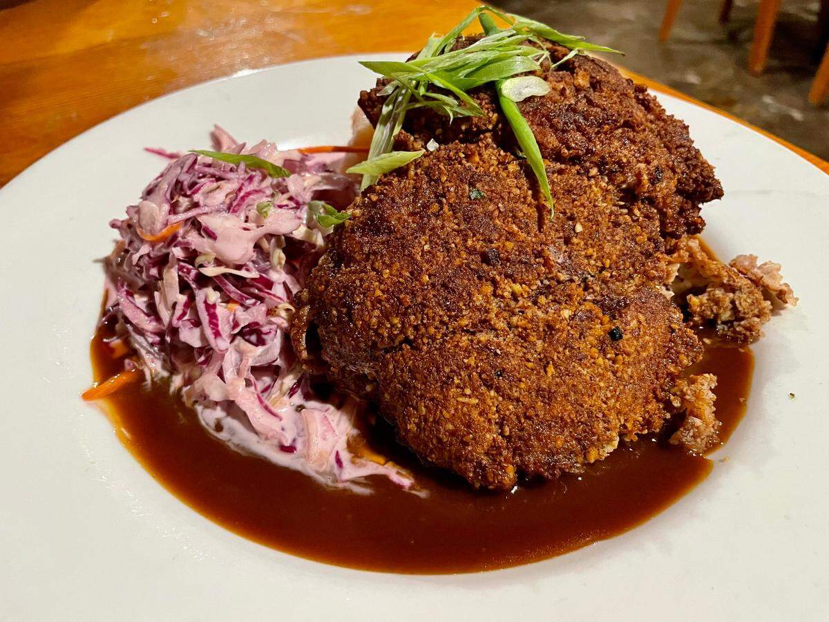 Smith Flat House’s pecan-crusted bourbon chicken comes with purple slaw and mashed potatoes.