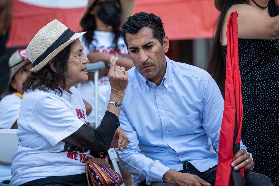 United Farm Workers co-founder Dolores Huerta talks with Assemblyman Robert Rivas, D-Salinas on the west steps of the Capitol last August at the end of a march to persuade Gov. Gavin Newsom to sign Assembly Bill 2183 that would allow farmworkers to seek a vote from home ballot to unionize.