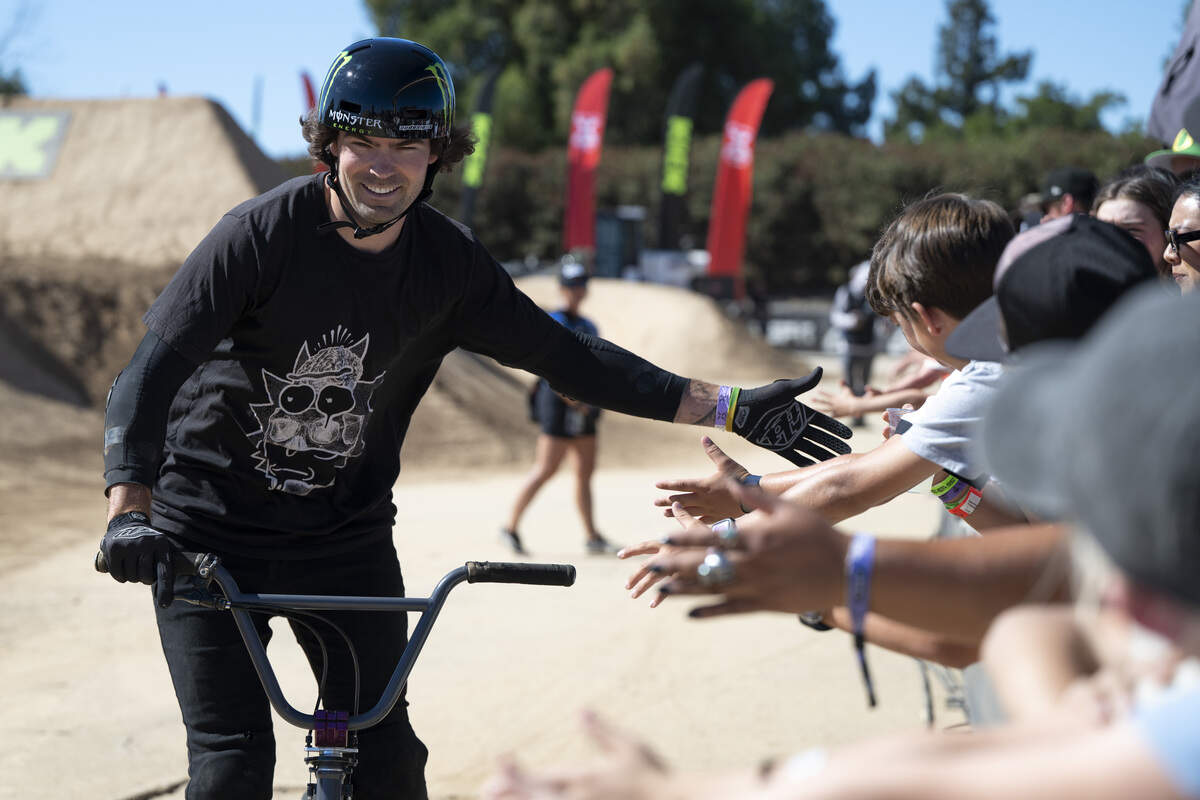 Mike Varga, of Canada, high-fives fans during the Stake BMX Dirt Best Trick event as a part of X Games Sacramento at Cal Expo in Sacramento on Sunday, June 28, 2026.