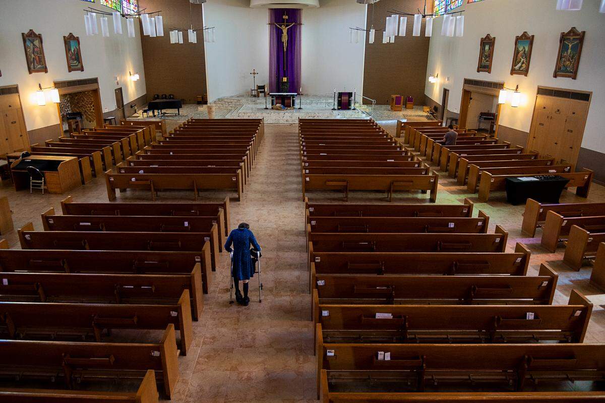 Parishioner Sue Kenny, 72, walks into the St. Ignatius Loyola Parish for prayer and quiet meditation during the beginning of the coronavirus pandemic outbreak on Friday, March 20, 2020 in Sacramento.