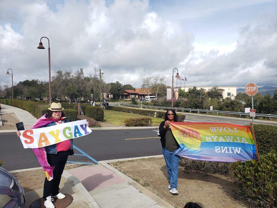 Los Angeles residents Renay Grace Rodriguez and Alecia Cornelius hold signs supporting LGBTQ rights as part of a protest outside the Ronald Reagan Presidential Library & Museum in Simi Valley on Sunday.