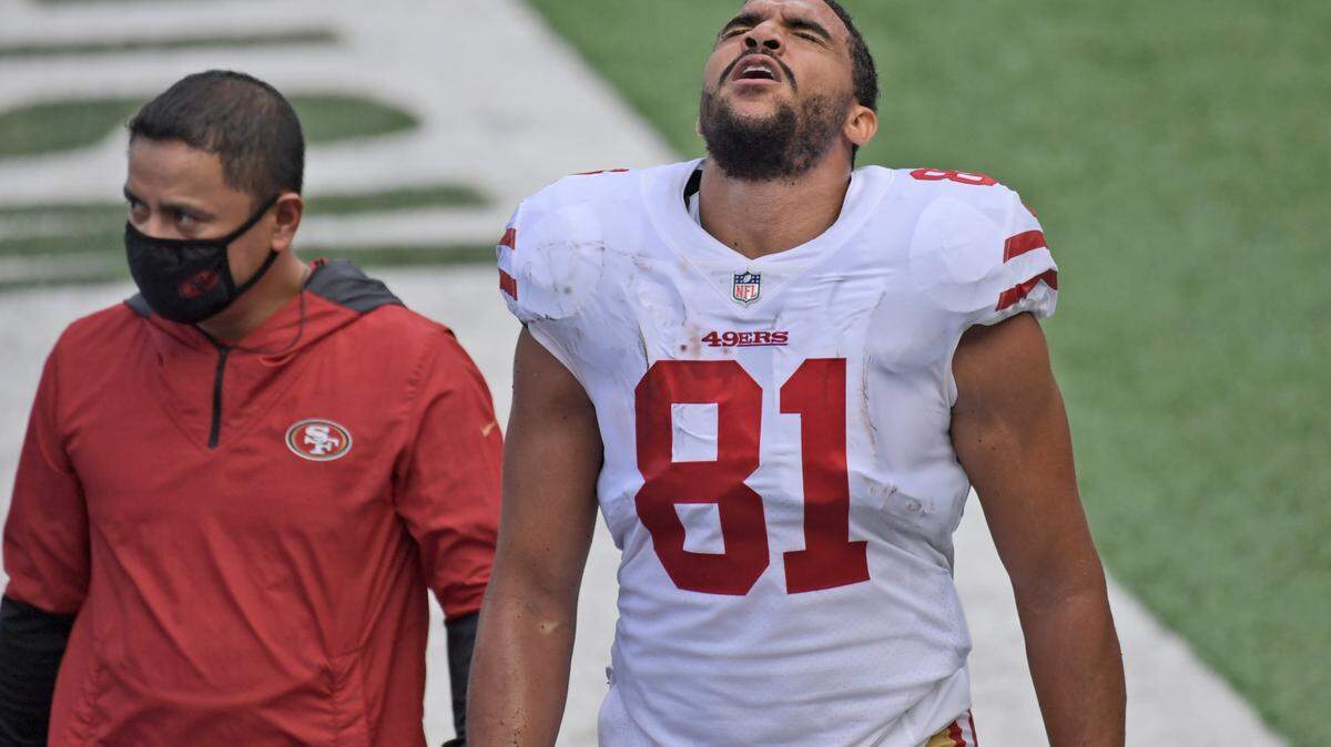 San Francisco 49ers’ Jordan Reed is escorted off the field during the first half of an NFL football game against the New York Giants.